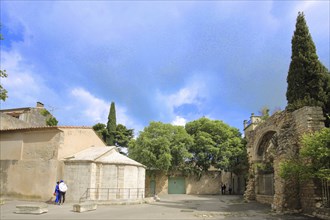 Place St-Blaise with Romanesque Chapelle St-Jean de Moustiers and archway, Arles, Bouches-du-Rhône,