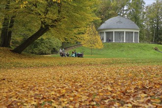 Family outing at a picnic at the historic carousel with autumn colours, park, fallen leaves, leaf