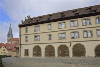 Historic tithe barn built in 1699 and St Mary Magdalene Church, Münnerstadt, Rhön, Lower Franconia,