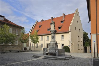 Luitpold fountain and historic building built in the 15th century with stepped gable,