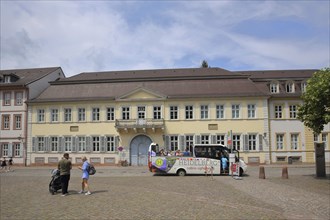 Karlsplatz with Palais Boisserée, people and tourist bus, touristsHeidelberg, Bergstrasse,