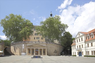 Market square with old guardhouse and tourist information centre with arcade and columns,