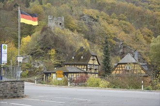 Lauksburg and Laukenmühle with German national flag, bus stop, Wispertal, Lorch, Taunus, Hesse,