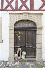 Art objects in front of a historic entrance gate, Mainbernheim, Lower Franconia, Bavaria, Germany,