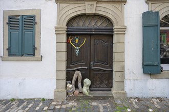 Art objects in front of a historic entrance gate, Mainbernheim, Lower Franconia, Bavaria, Germany,