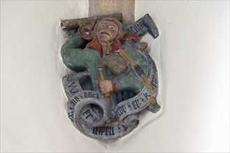 Fool figure with bagpipes, console stone in St Martin's Church, Plieningen, Baden-Württemberg,