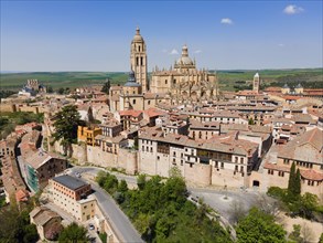 Panorama of a medieval city with a large church surrounded by historic buildings and nature under a