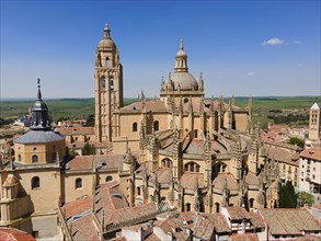 Historic church with Gothic and Renaissance elements surrounded by a medieval town under a clear