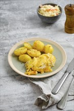 Pork chops with melted cheese topping and roasted potato