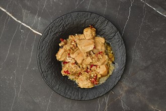 Overhead view of portion of chicken fillet ragout with walnuts