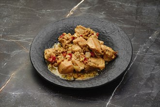 Traditional Georgian meal, kharcho, chicken fillet ragout with walnuts