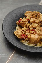 Closeup view of plate with chicken stew with walnuts