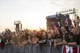 Festival-goers in the front row give the devil's salute at the Wacken Open Air in Wacken. The