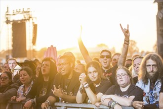 Festival-goers in the front row give the devil's salute at the Wacken Open Air in Wacken. The