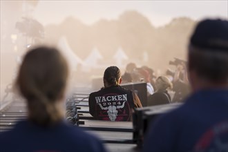 Employees with Wacken waistcoat in the stage pit at the Wacken Open Air in Wacken. The traditional