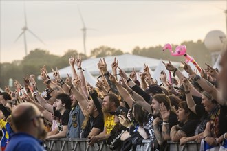 Festival-goers in the front row give the devil's salute at the Wacken Open Air in Wacken. The