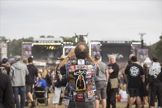 An elderly gentleman photographs the two main stages at the Wacken Open Air in Wacken. The