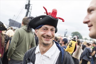 Festival visitor dressed as a pirate with parrot and octopus at the Wacken Open Air in Wacken. The