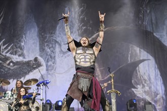 Captain Feuerschwanz, singer of the band Feuerschwanz, shows the metal salute at the Wacken Open