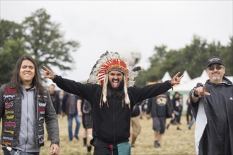 A festival visitor dressed up as an Indian at the Wacken Open Air in Wacken. The traditional metal