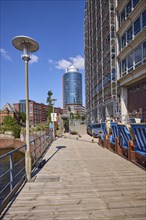 Wooden jetty with lantern and beach chairs, Hanseatic Trade Centre with scaffolding and Columbus