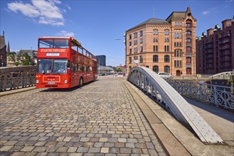 Red double-decker bus during a tourist city tour on the Kannengiesser Bridge in Hamburg's