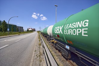 Road with railway tracks and tank wagons from GBX Leasing Europe in the Port of Hamburg, Free and