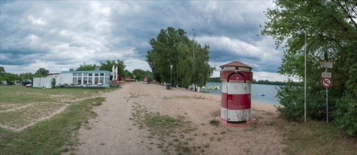 Old round red and white striped changing room from GDR times in the shape of a lighthouse on the