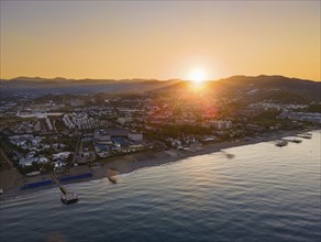 The sun rises behind the mountains of the Taurus Mountains on the Turkish Riviera. (Aerial view