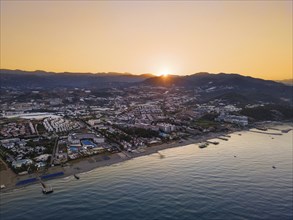 The sun rises behind the mountains of the Taurus Mountains on the Turkish Riviera. (Aerial view