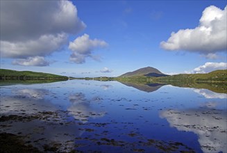 Calm lake with cloud reflections and mountains in the background, Letterfrack, Connemara National