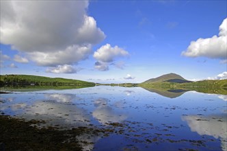 Calm lake with cloud reflections and mountain hills in the background, Letterfrack, Connemara