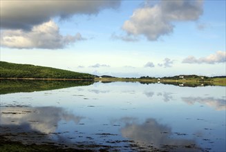 Calm lake with cloud reflections and green shores, silence, holiday, Letterfrack, Connemara