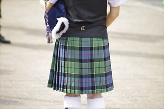 A person in a traditional Scottish kilt from behind, tradition, history, Scotland, Great Britain