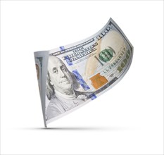 One hundred dollar bill floating down to surface with drop shadow isolated on a white background