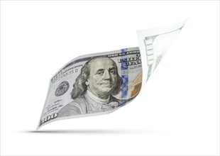 One hundred dollar bill floating down to surface with drop shadow isolated on a white background