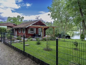 Fenced wooden holiday home with lawn on Lake Jersleben, Jersleben, Saxony-Anhalt, Germany, Europe