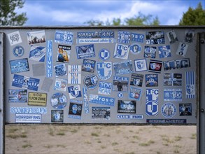 Stickers of Ultras, horror fans, hardcore fans of the football club 1. FC Magdeburg on a board at