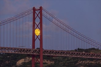 Full Moon and 25 April Bridge. Lisbon, Portugal, Europe