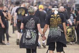 Elderly couple with Wacken shirts at the Wacken Open Air in Wacken. The traditional metal festival