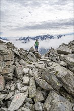 Mountaineer in a rocky saddle, Lapenscharte with view of mountain peaks, Berliner Höhenweg,