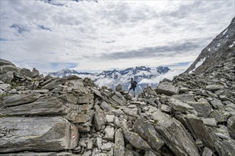 Mountaineer in a rocky saddle, Lapenscharte with view of mountain peaks, Berliner Höhenweg,