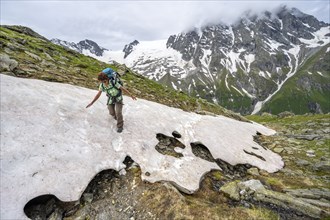 Mountaineer climbing over a snowfield to the Lapenscharte, Berliner Höhenweg, Zillertal Alps,