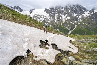 Mountaineer climbing over a snowfield to the Lapenscharte, Berliner Höhenweg, Zillertal Alps,