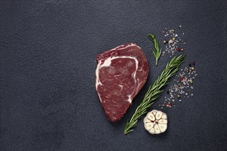 Raw steak, beef steak, rib eye steak, on the table, top view, no people, on a dark background