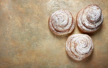 Bakery product, lemon twist, with white glaze, sweet bun, muffin, pastries, top view, no people