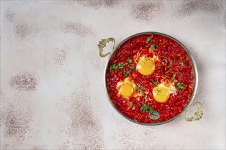 Shakshuka, breakfast, fried eggs in tomato sauce, with spices and herbs, homemade, no people