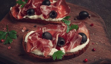 Sandwich with cream cheese, prosciutto with olives, breakfast