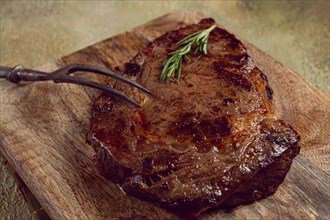 Grilled steak, beef steak, rib eye steak, on a chopping board, top view, no people