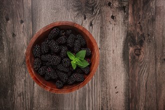 Blackberries, in a wooden bowl, top view, no people